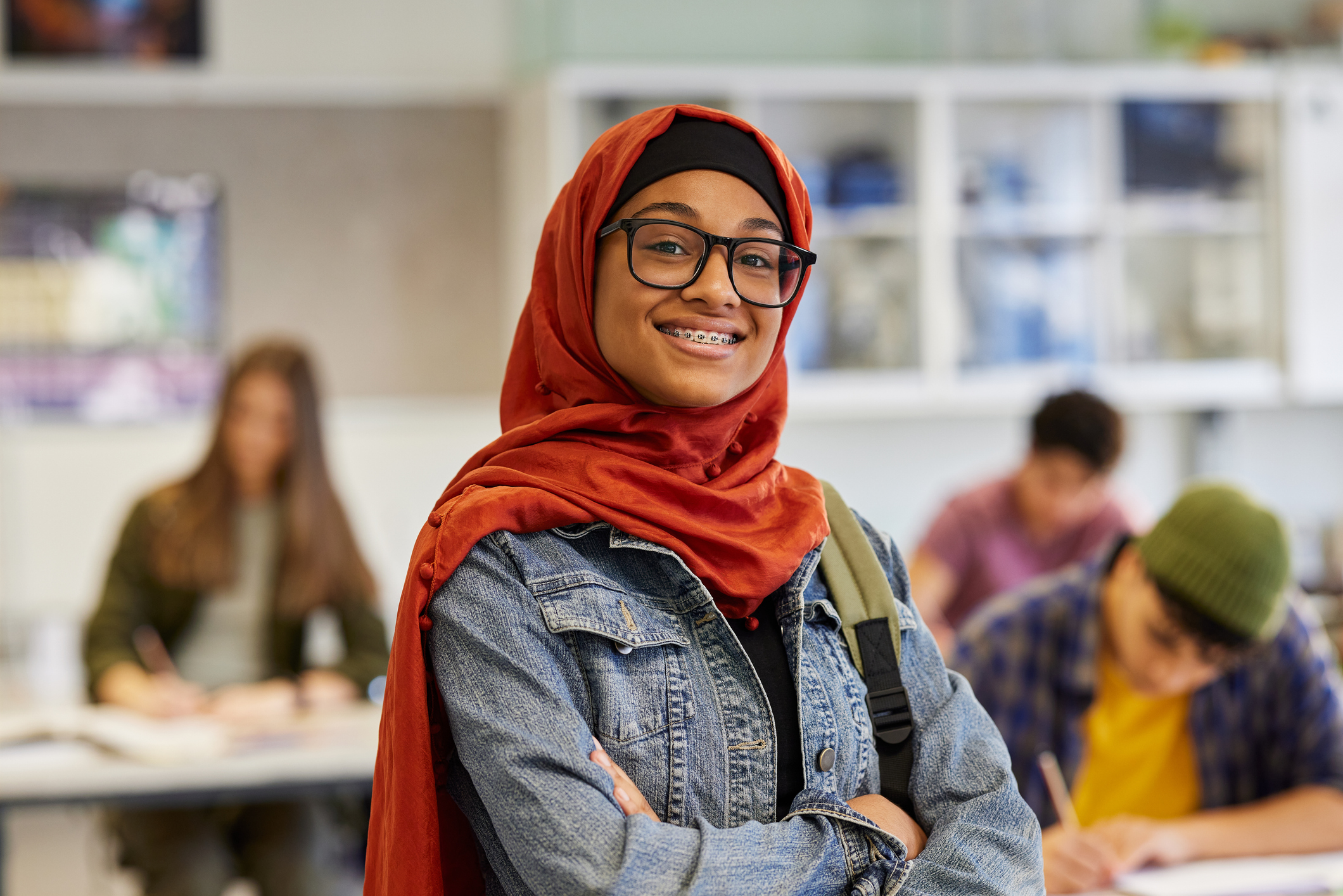 Sixth form student smiling in a classroom environment.